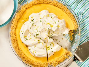 An Atlantic Beach pie with a graham cracker crust, topped with whipped cream, and partially sliced