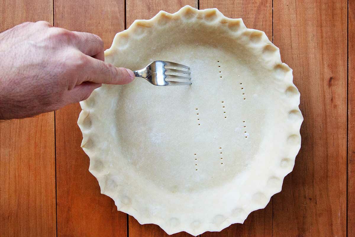 Southern chess pie crust is pricked with a fork.