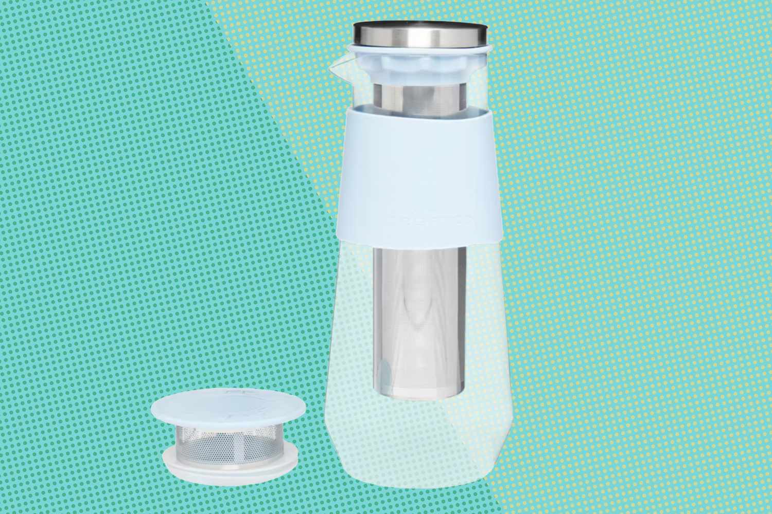 A cold brew coffee maker set on a textured background, including the main container and an additional filter lid