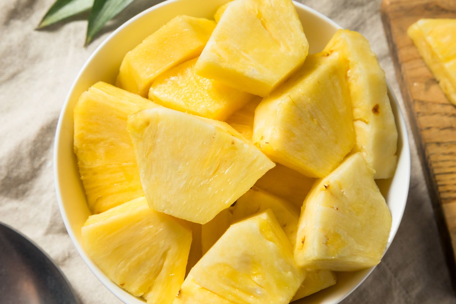 A bowl containing pieces of cut pineapple