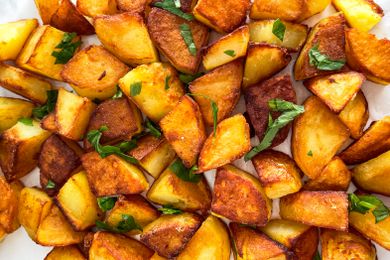 Closeup overhead view of cubed roasted potatoes with parsley
