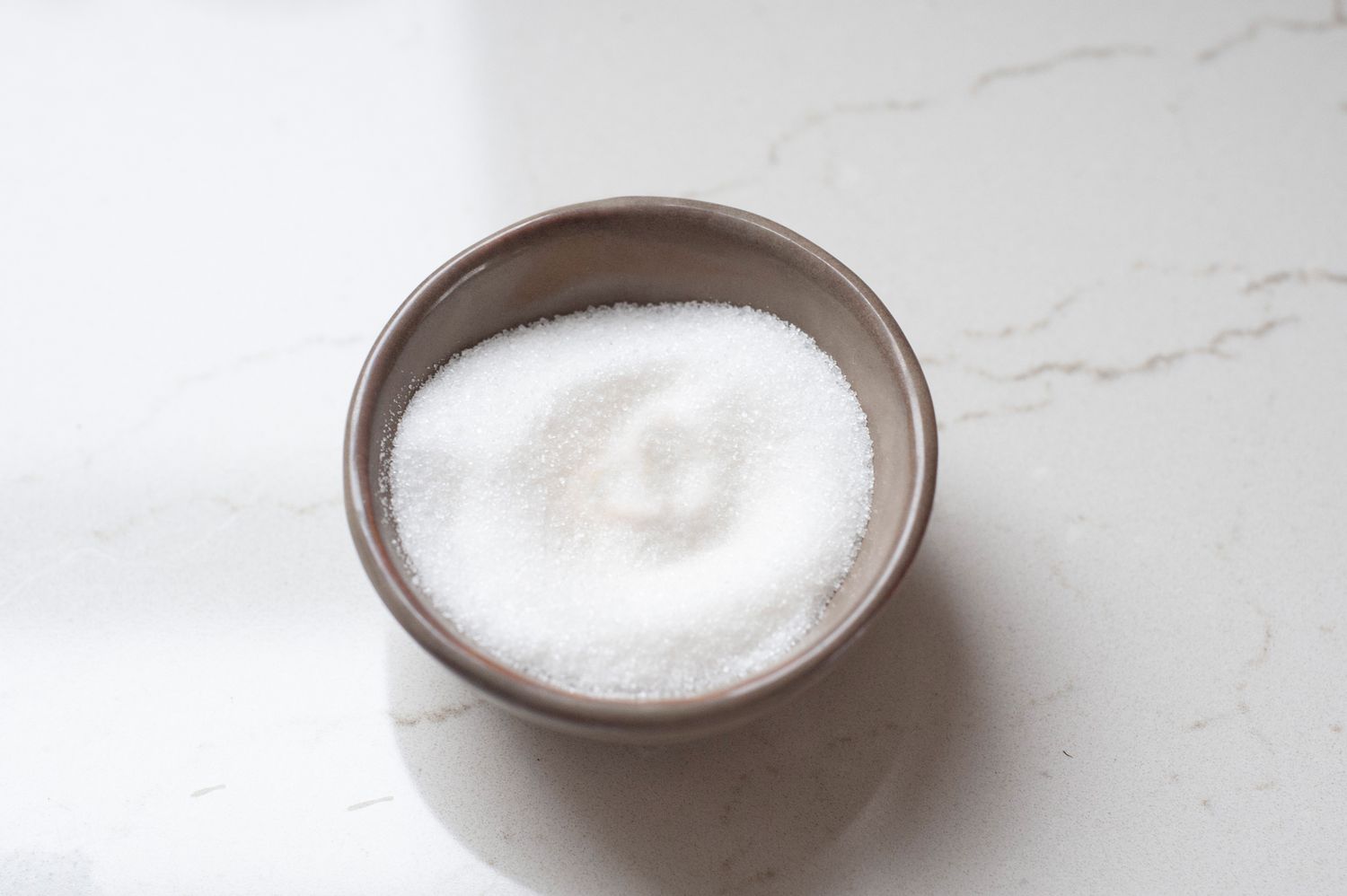 A small bowl of sugar to make easy kettle corn.