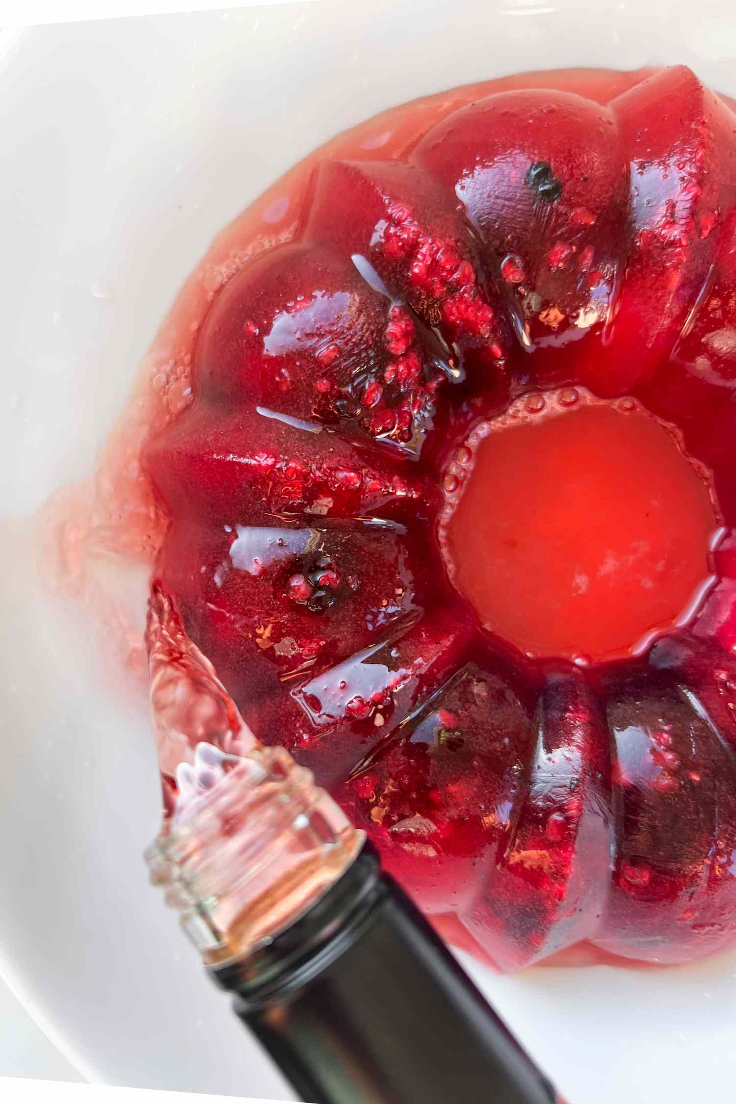RosÃ© being poured into berry ice ring