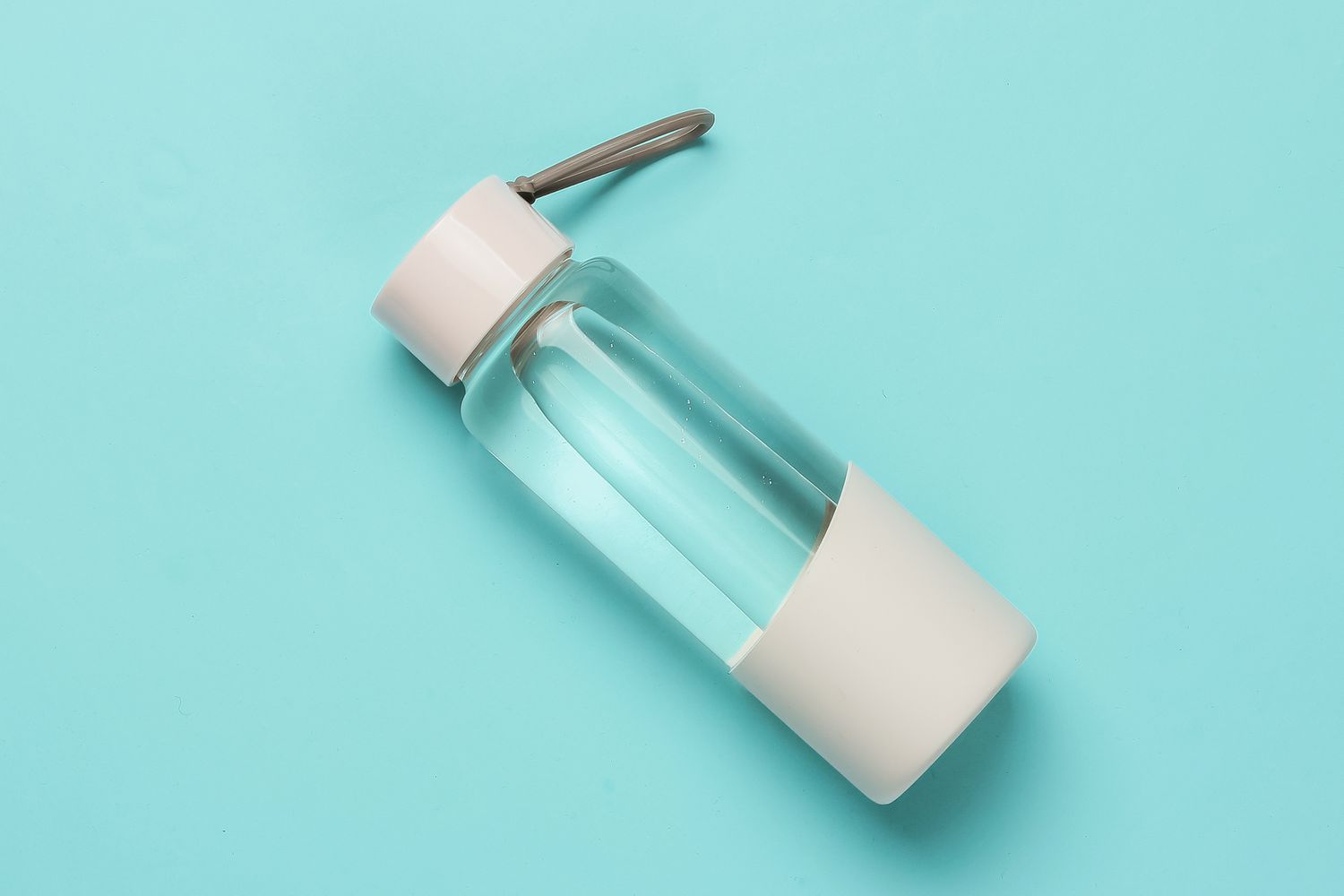 Bottle of water for sports and outdoor activities on blue background. Top view