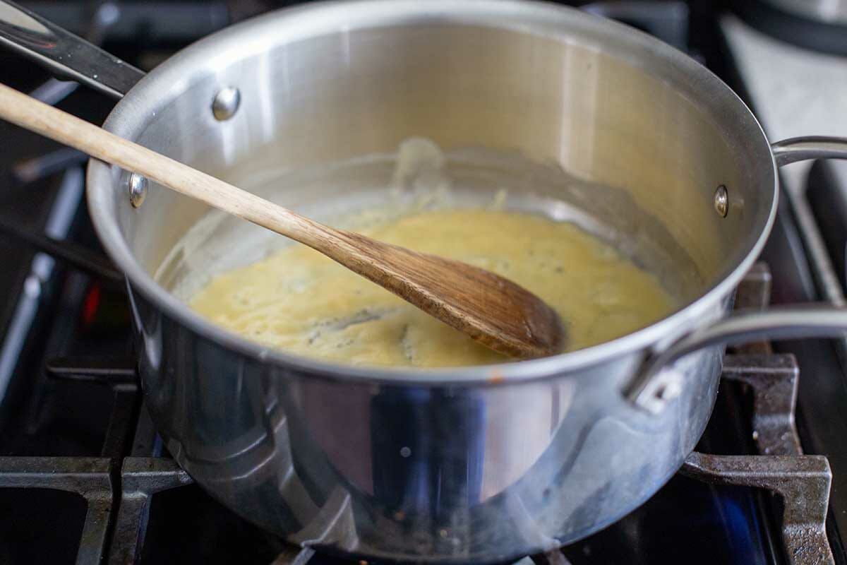 Butter and flour are in a saucepan to make a roux for Baked Cheesy Cauliflower.