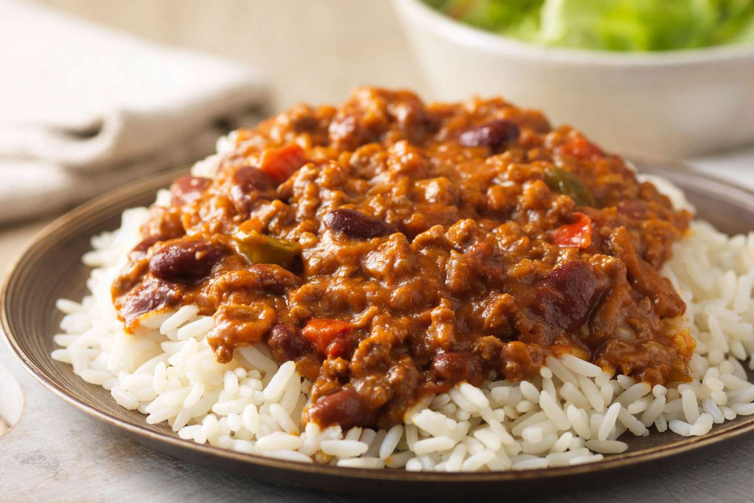 chili on a bed of rice on a plate