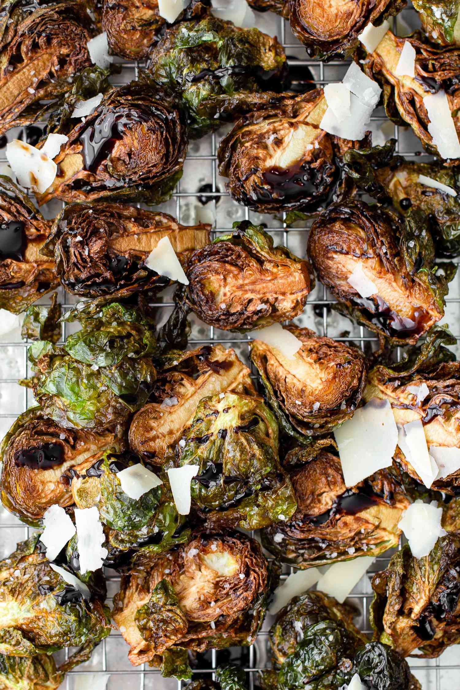 On a a Cooling Rack over a Baking Pan, Deep Fried Brussels Sprouts Topped with Shaved Parmesan and Balsamic Vinegar 
