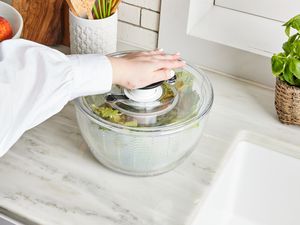 hand pumping OXO salad spinner