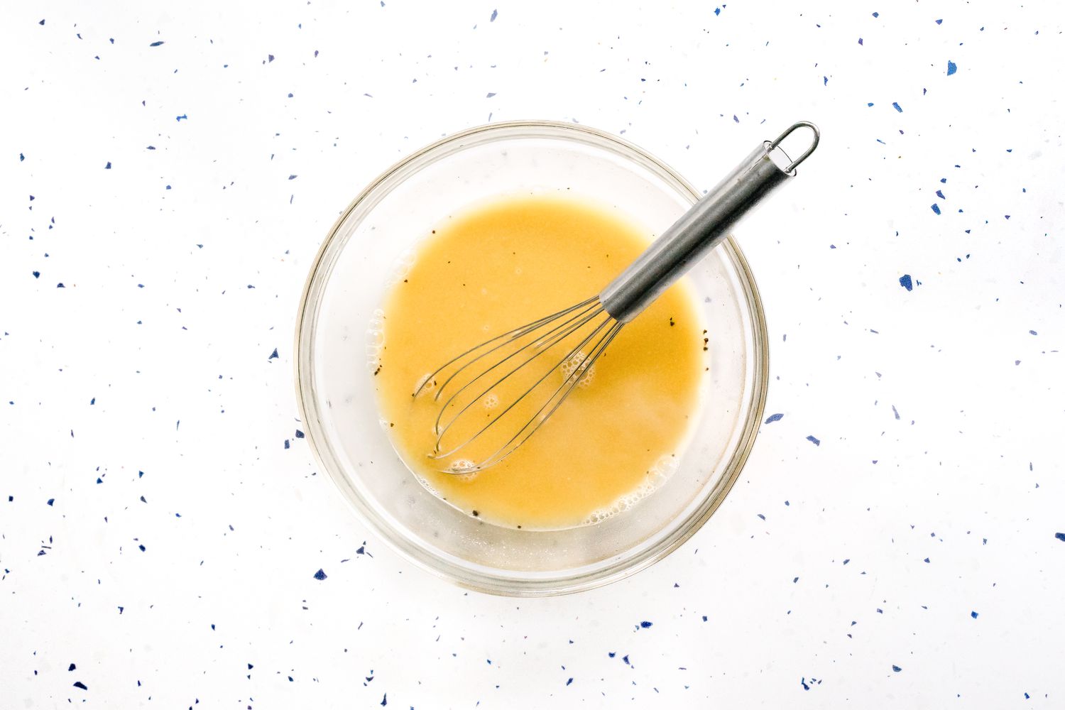 Bowl of Cashew Butter, Nutritional Yeast, and Miso Mixed Together for Vegan Cacio e Pepe Recipe 
