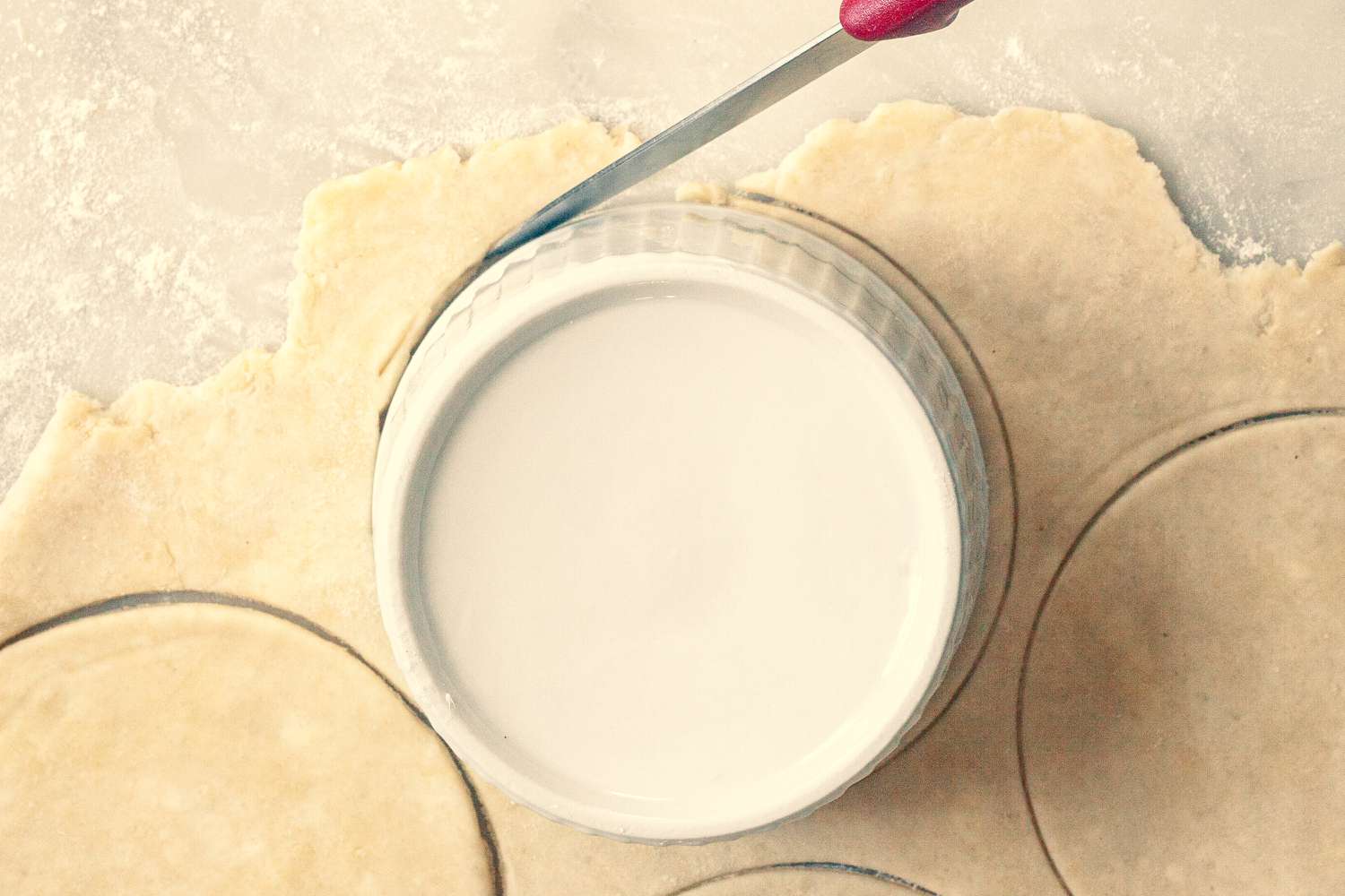Using lids to cut dough to top turkey pot pie