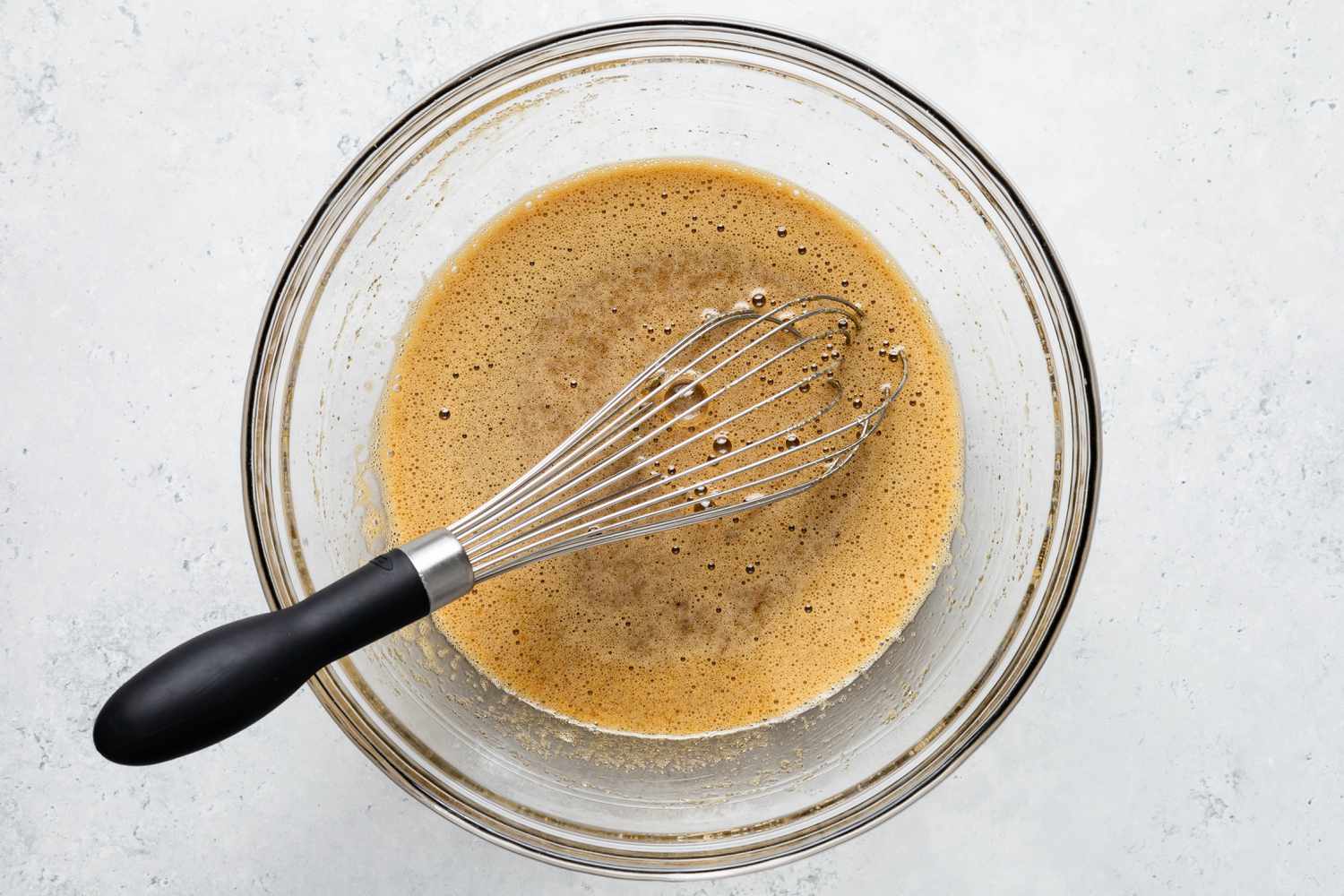 Brown Sugar Mixed Into Bowl of Frothy Eggs for Retro Sad Cake Recipe