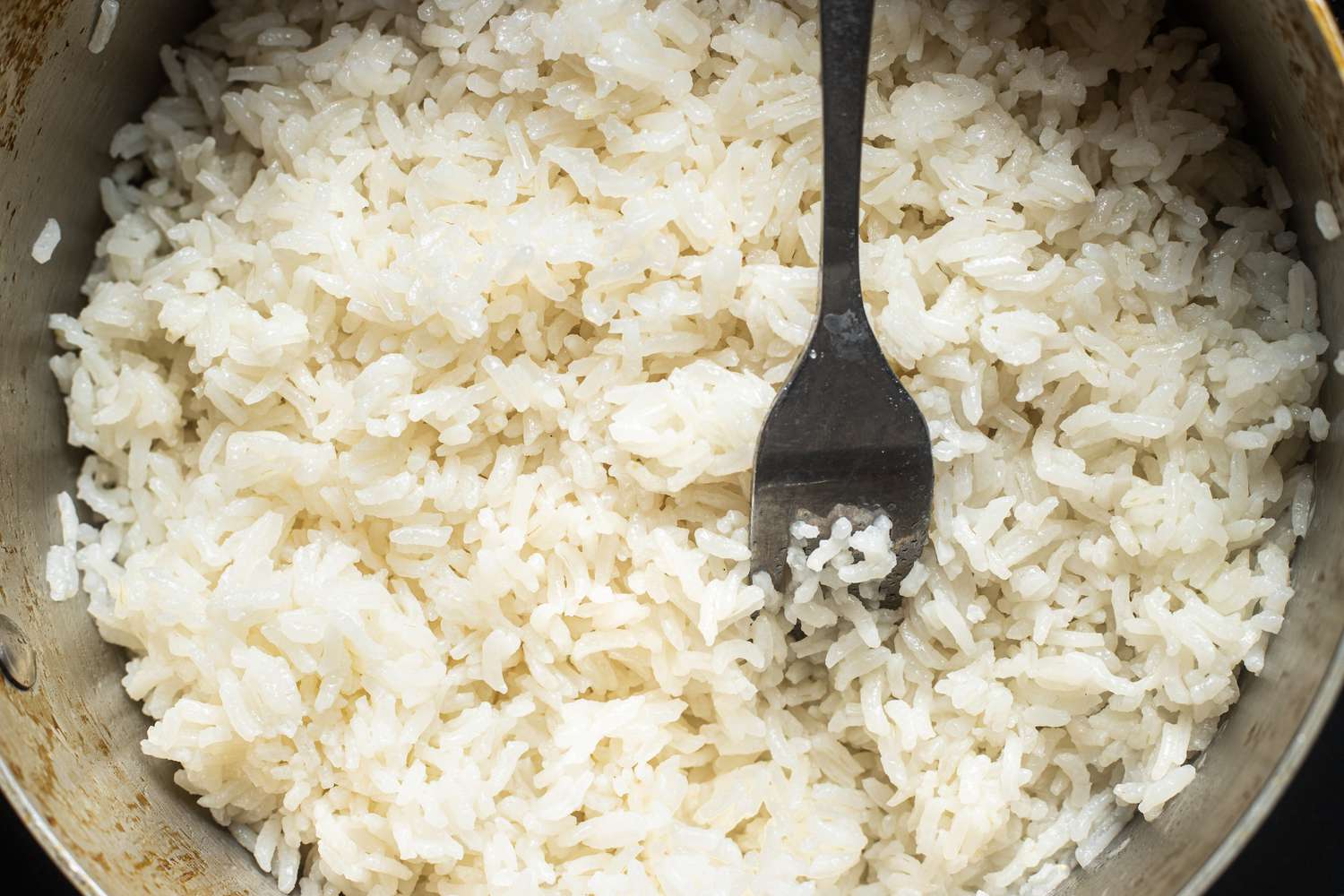 Fork Used to Fluff Up Coconut Lime Rice