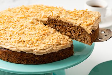 Coffee Coconut Banana Bread Cake on a Cake Platter With a Cut Slice Lifted Using a Pie Server