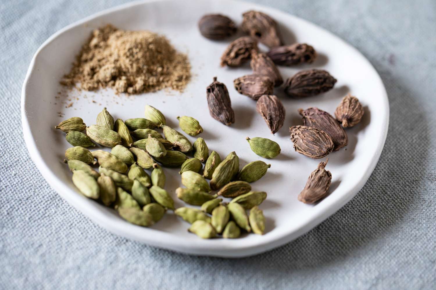 Cardamom spices on white plate