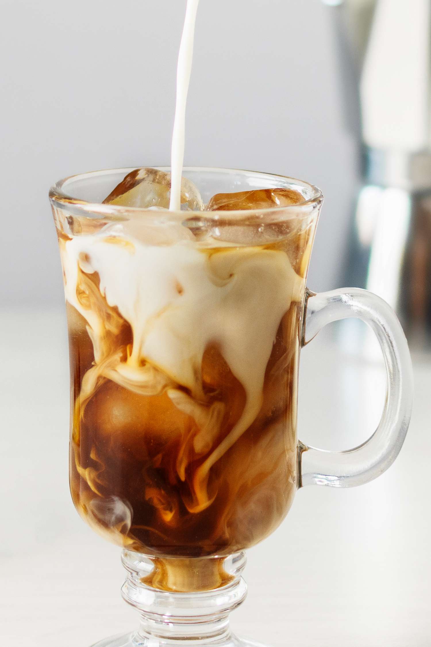 Homemade creamer poured into a glass of ice coffee