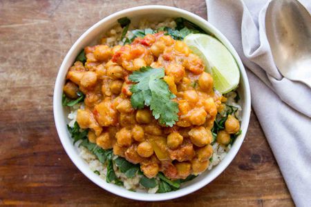 Slow Cooker Chickpea Curry served in a bowl with spinach and rice