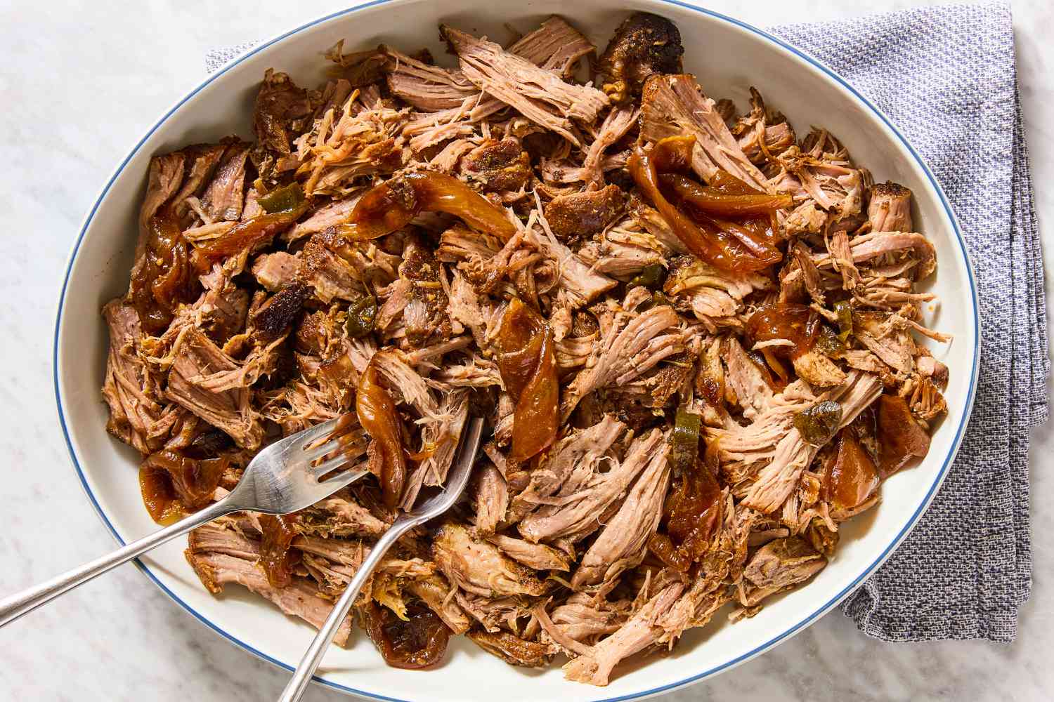 Texas-Style Pulled Pork in a large bowl with two forks