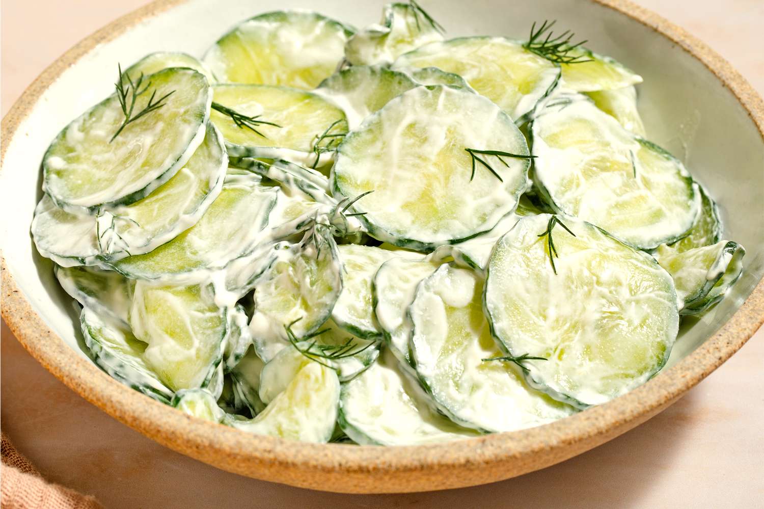 Cucumber salad with dill in a bowl