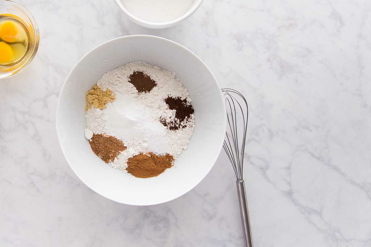 Flour and spices in a mixing bowl to make The Best Pumpkin Cake with Cream Cheese Frosting.
