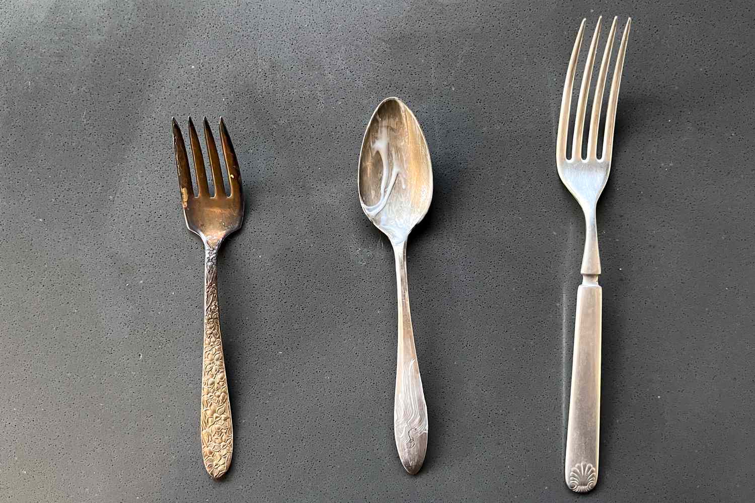 From L to R: a Tarnished Silver Fork, a Spoon With Toothpaste, and a Polished Fork on the Counter for How to Clean Silver