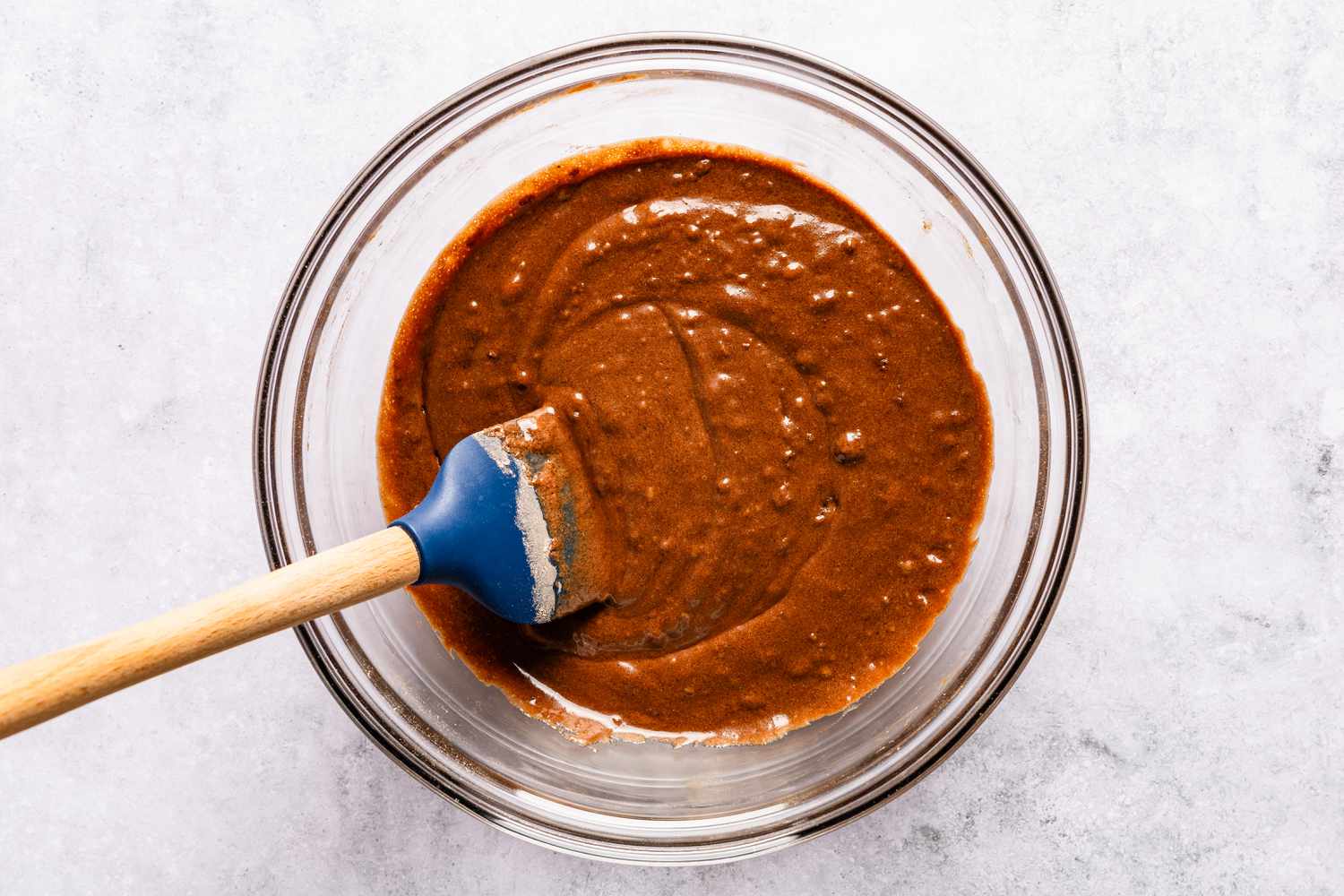 first layer of batter in a bowl for chocolate pudding cake recipe 