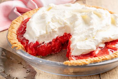 fresh strawberry pie with a slice cut out