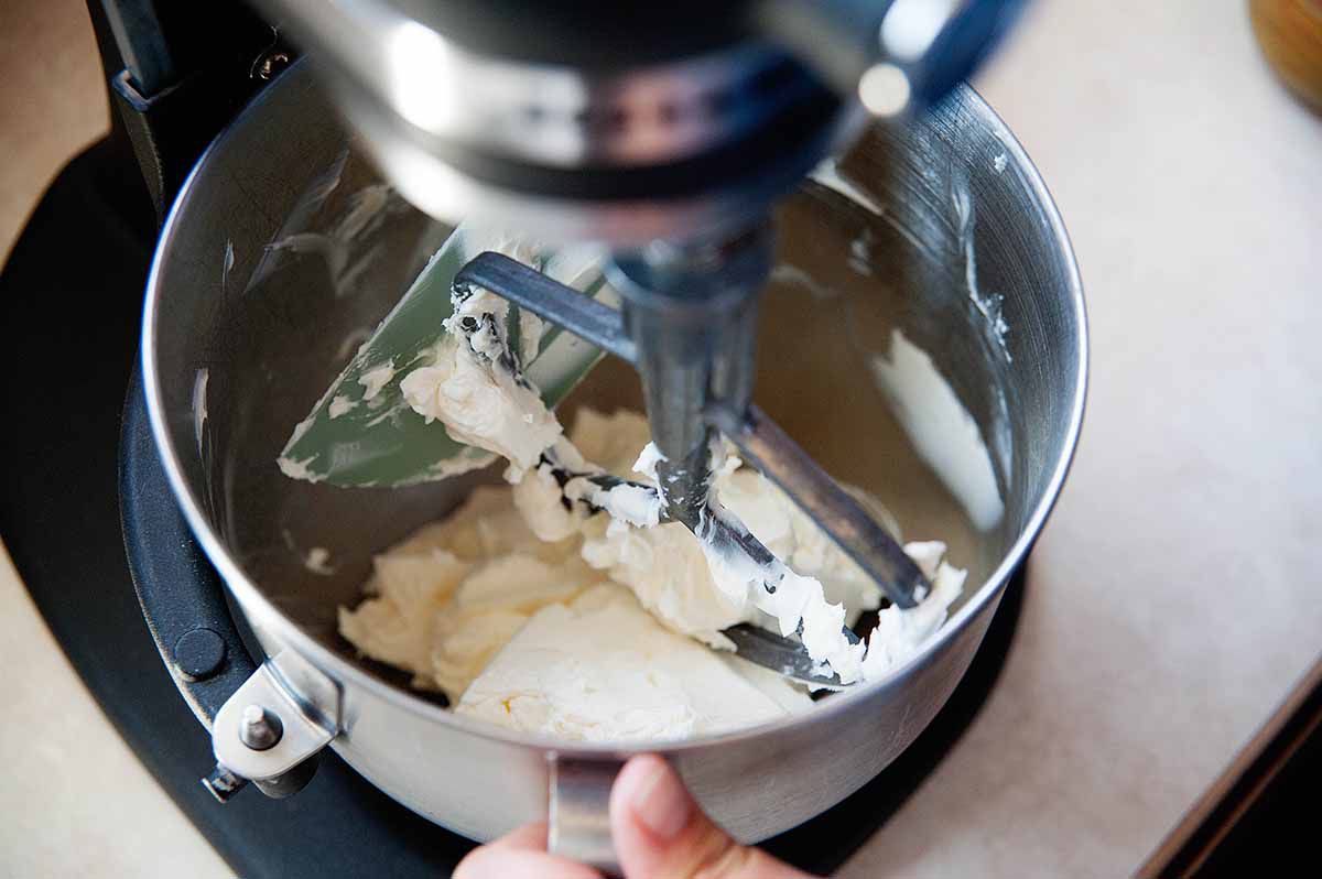 Cream cheese in the bottom of a mixing bowl for cheesecake