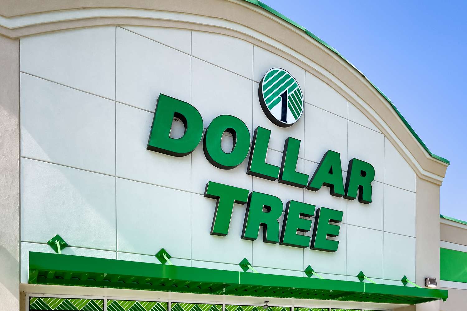 Dollar Tree storefront featuring the company logo and a green awning under an arched roof