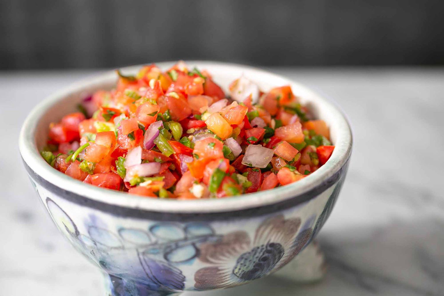 tomato salsa in a bowl showing chopped tomatoes and onion