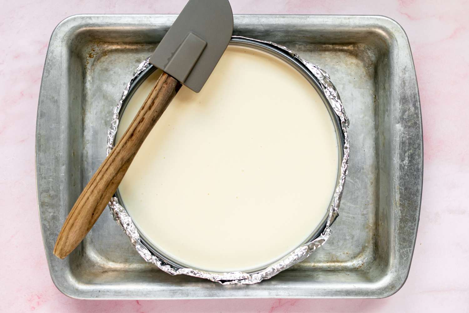 A New York cheesecake recipe in a pan and ready to be baked.