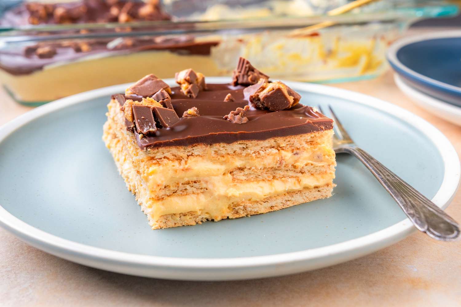 Peanut Butter Éclair Cake on a dessert plate with a fork