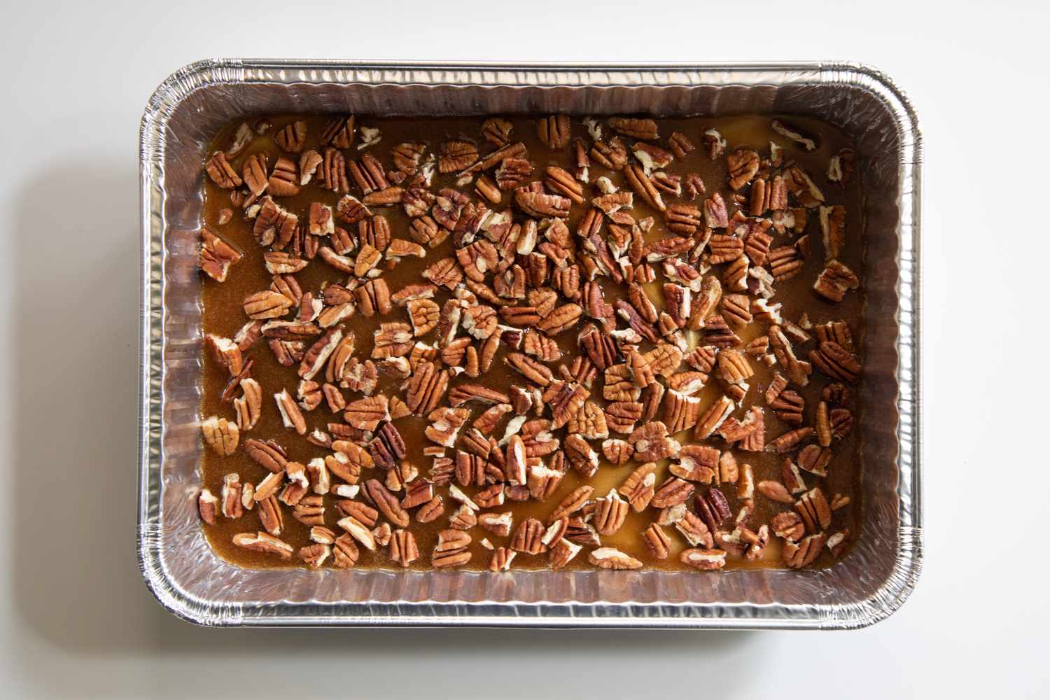 A baking pan with pecans on the bottom to make sticky buns.