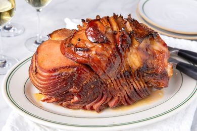 A glazed spiralcut ham presented on a serving platter