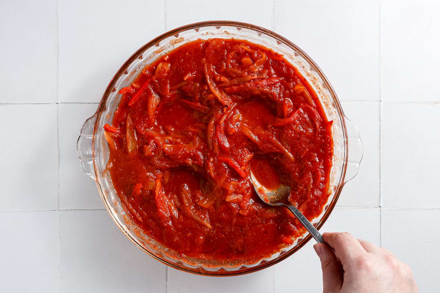 Spoon Used to Create Wells in the Microwave Shakshuka Sauce 