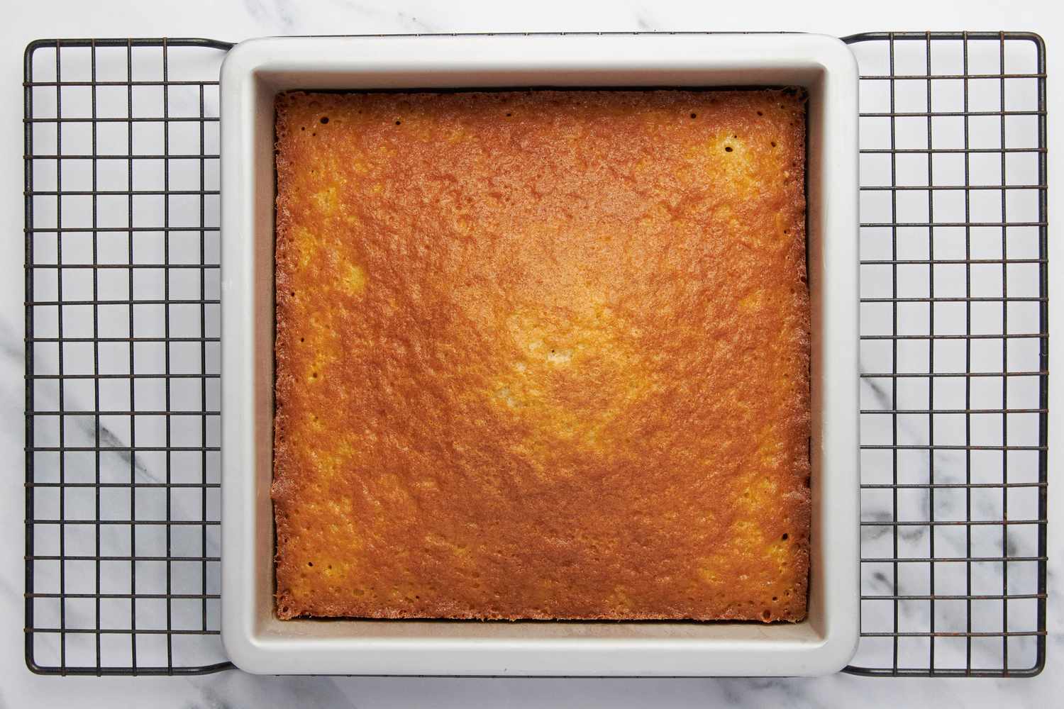 Baked lazy daisy cake on a cooling rack (still in the baking pan)