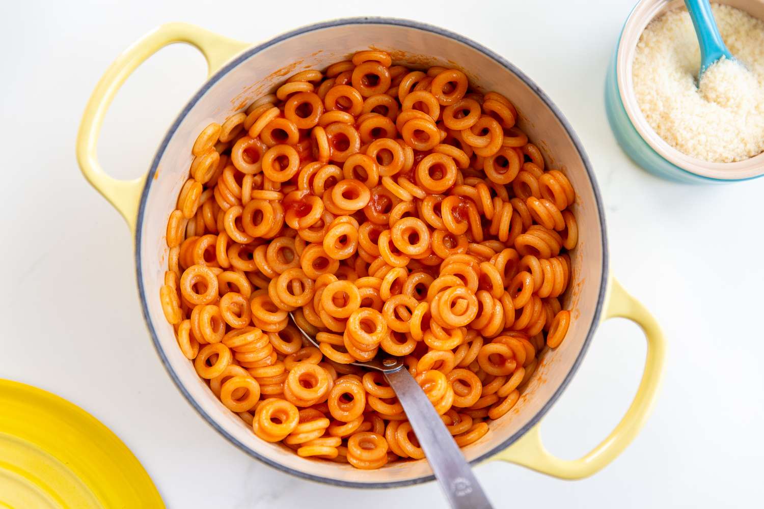 A pot of homemade spaghettios with a spoon