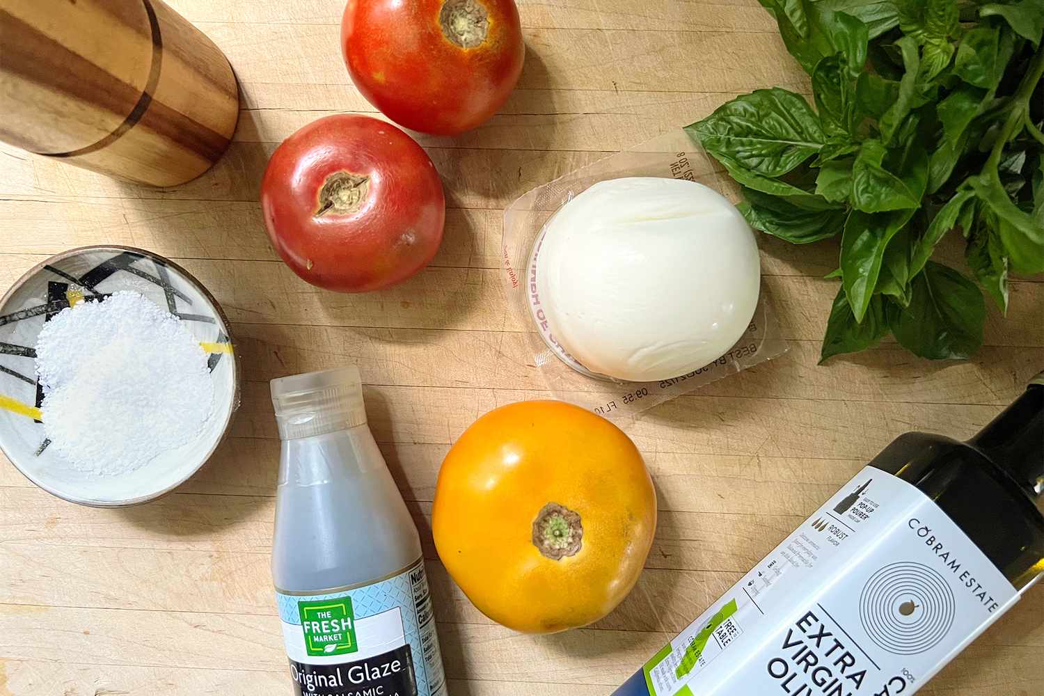 Ingredients for Caprese Salad: tomatoes, fresh mozzarella ball, extra-virgin olive oil, basil, balsamic glaze, salt and pepper