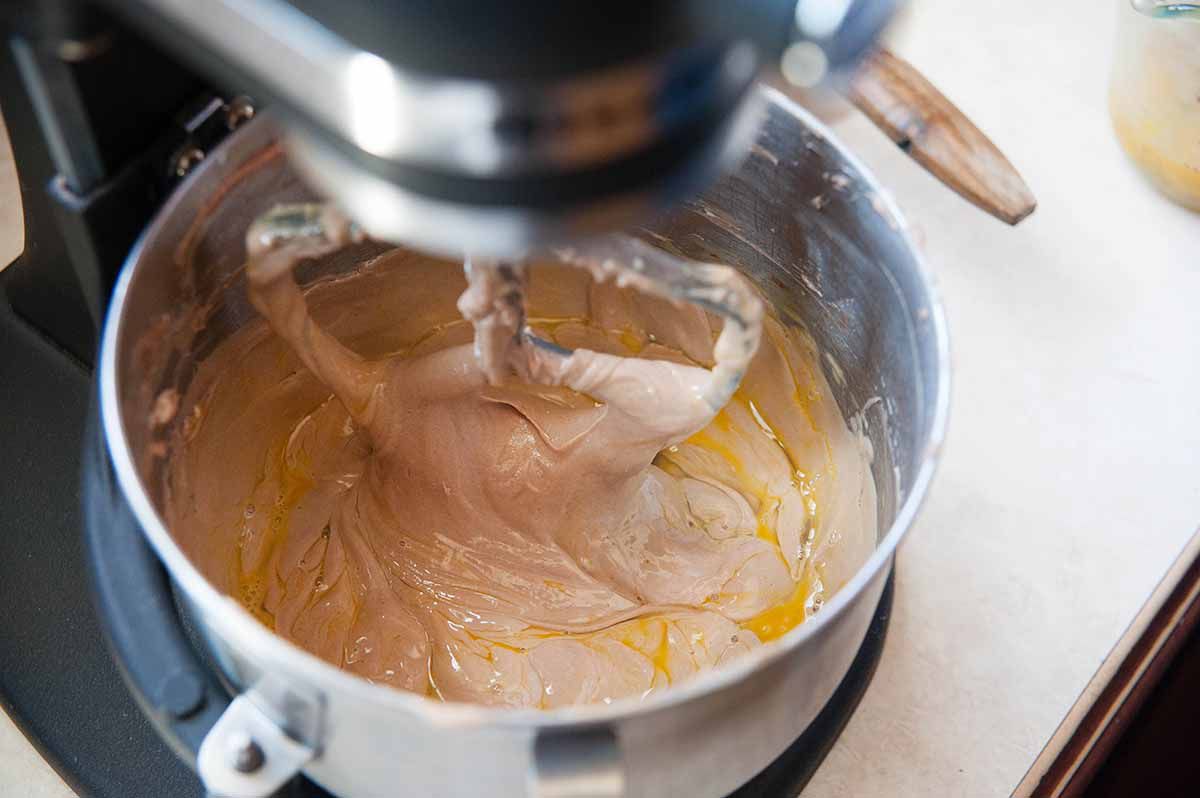 Mixing chocolate cream cheese and eggs for chocolate cheesecake.