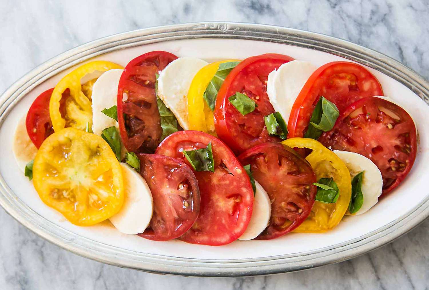 caprese salad with heirloom tomatoes, mozzarella and basil
