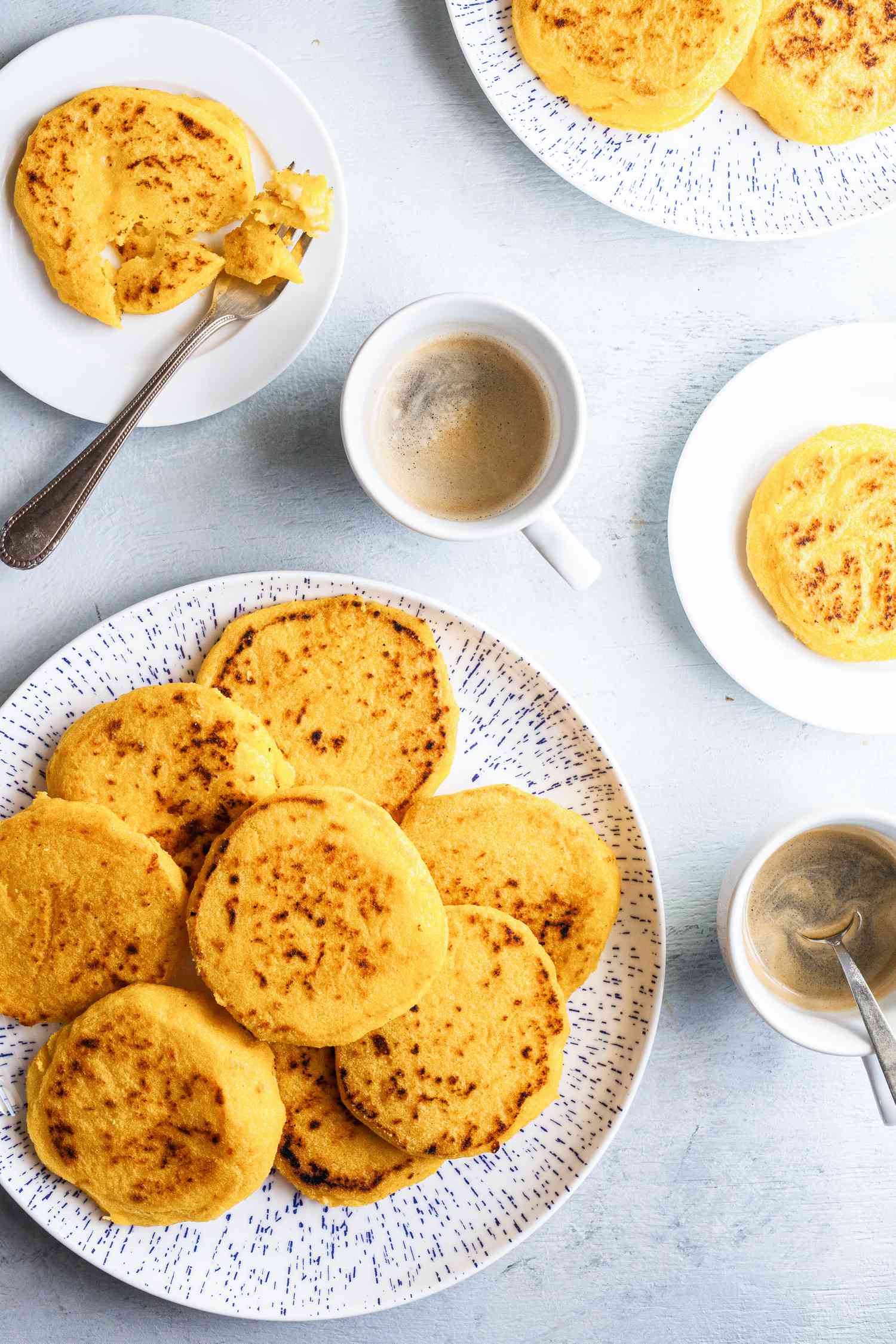 Arepas con Queso served with coffee.