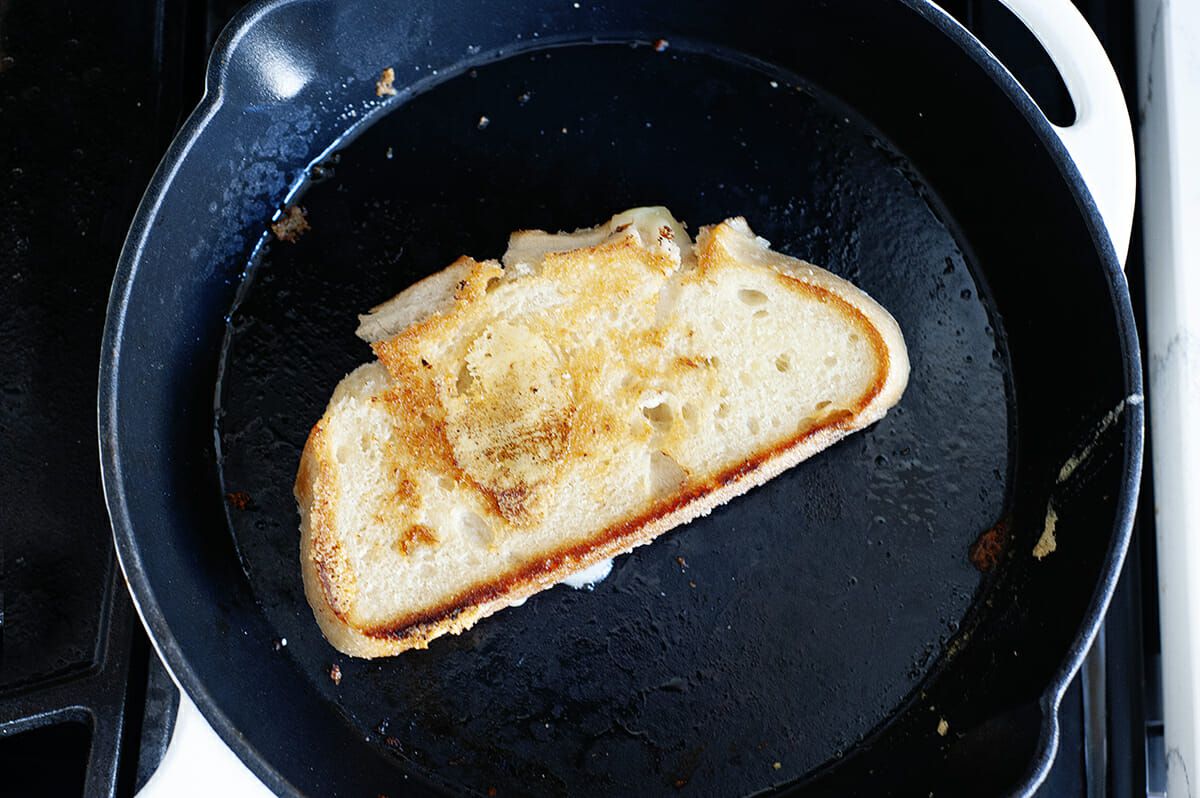 A grilled cheese sandwich in a cast iron skillet.