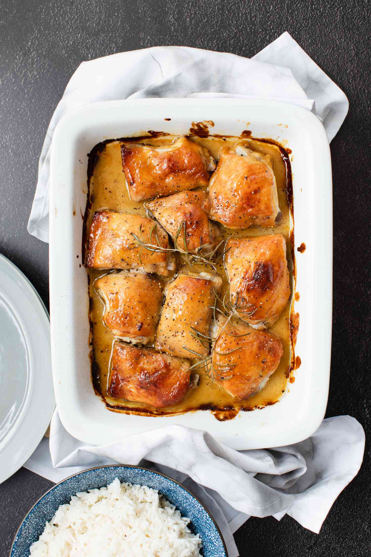 Overhead view of baked chicken in a casserole dish.