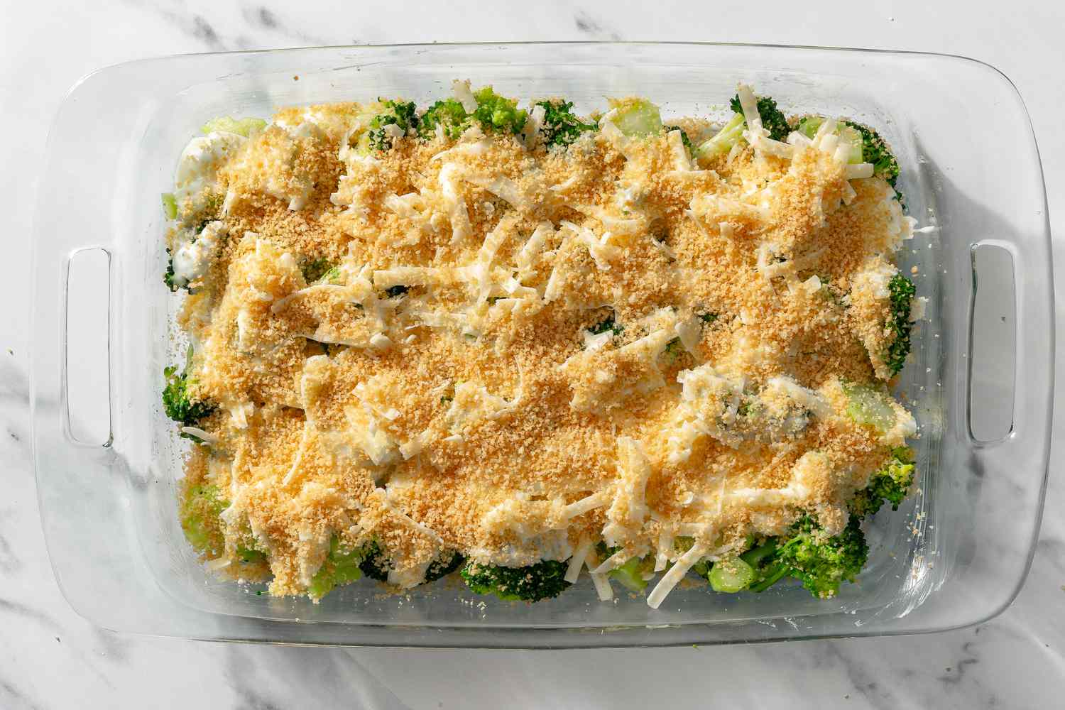casserole topped with breadcrumbs in a baking dish for My Mom’s Famous Broccoli Cheese Casserole