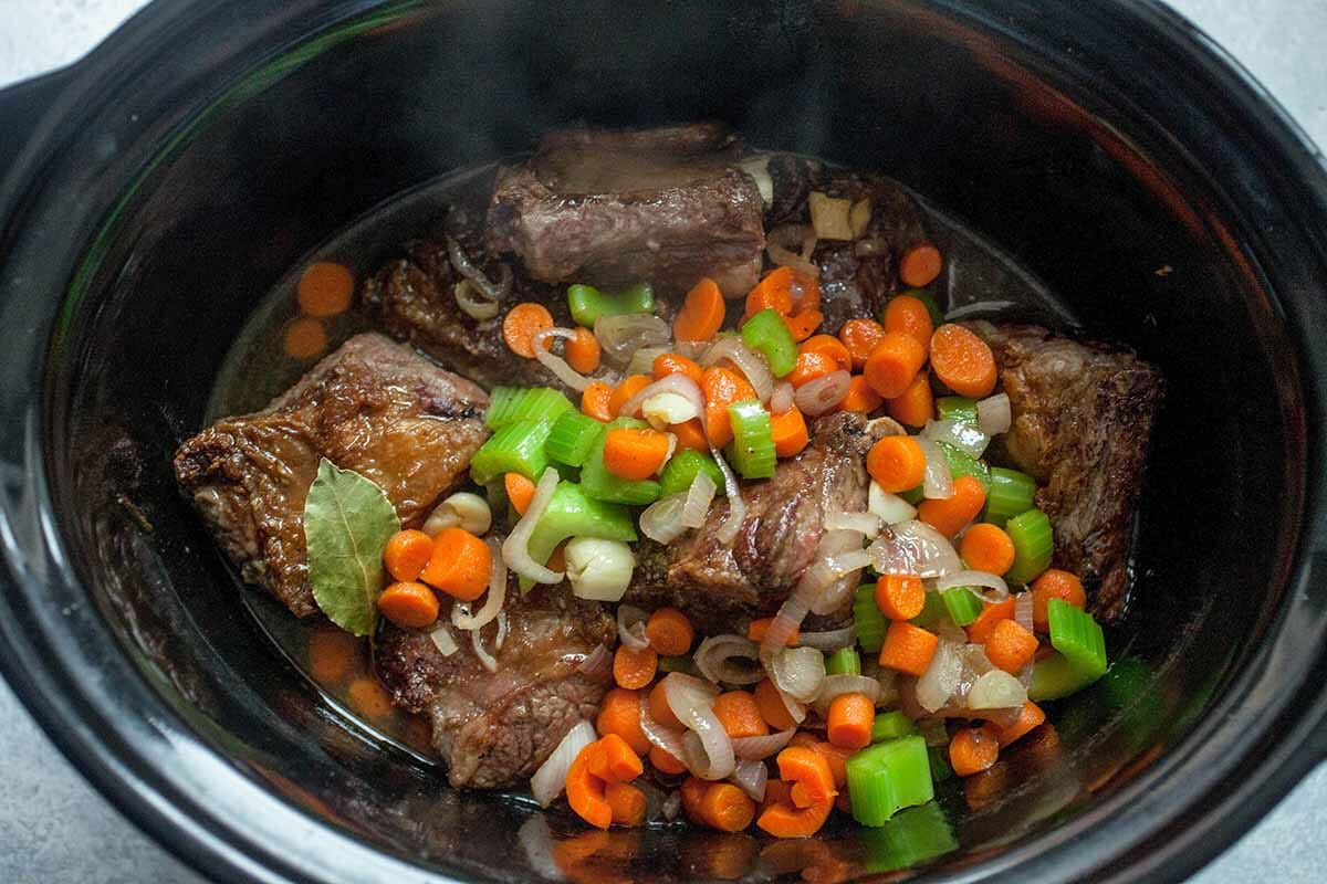 Combine short ribs, celery, carrots, and broth in a crock pot