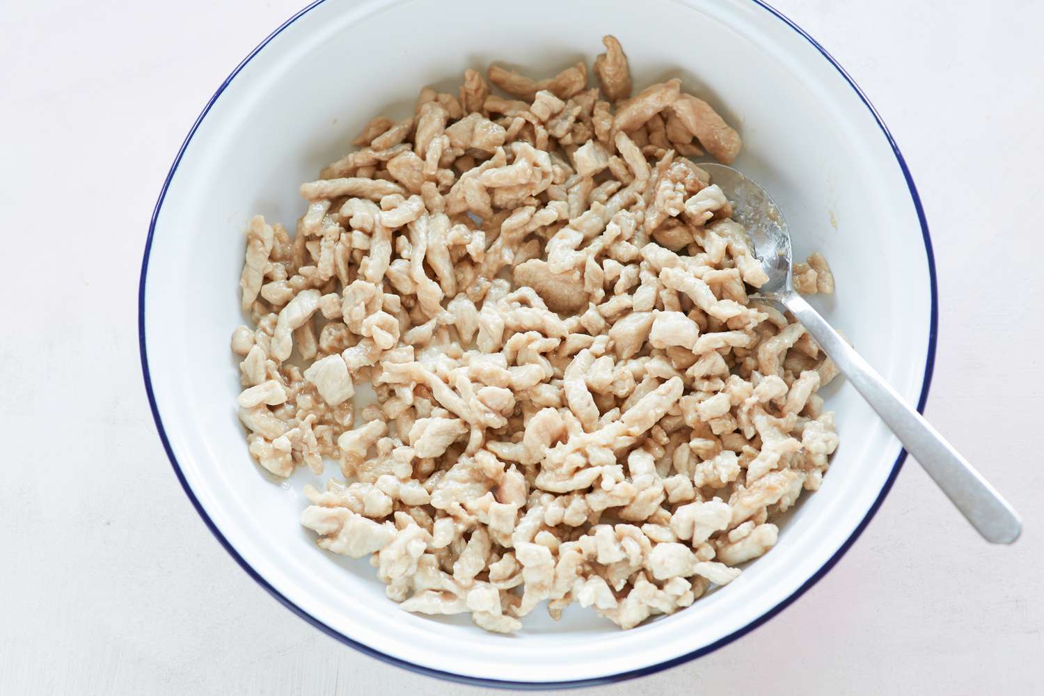 Overhead view of cooked pork to make spring rolls.