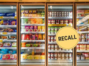 Grocery store freezer with various frozen items and a recall warning label