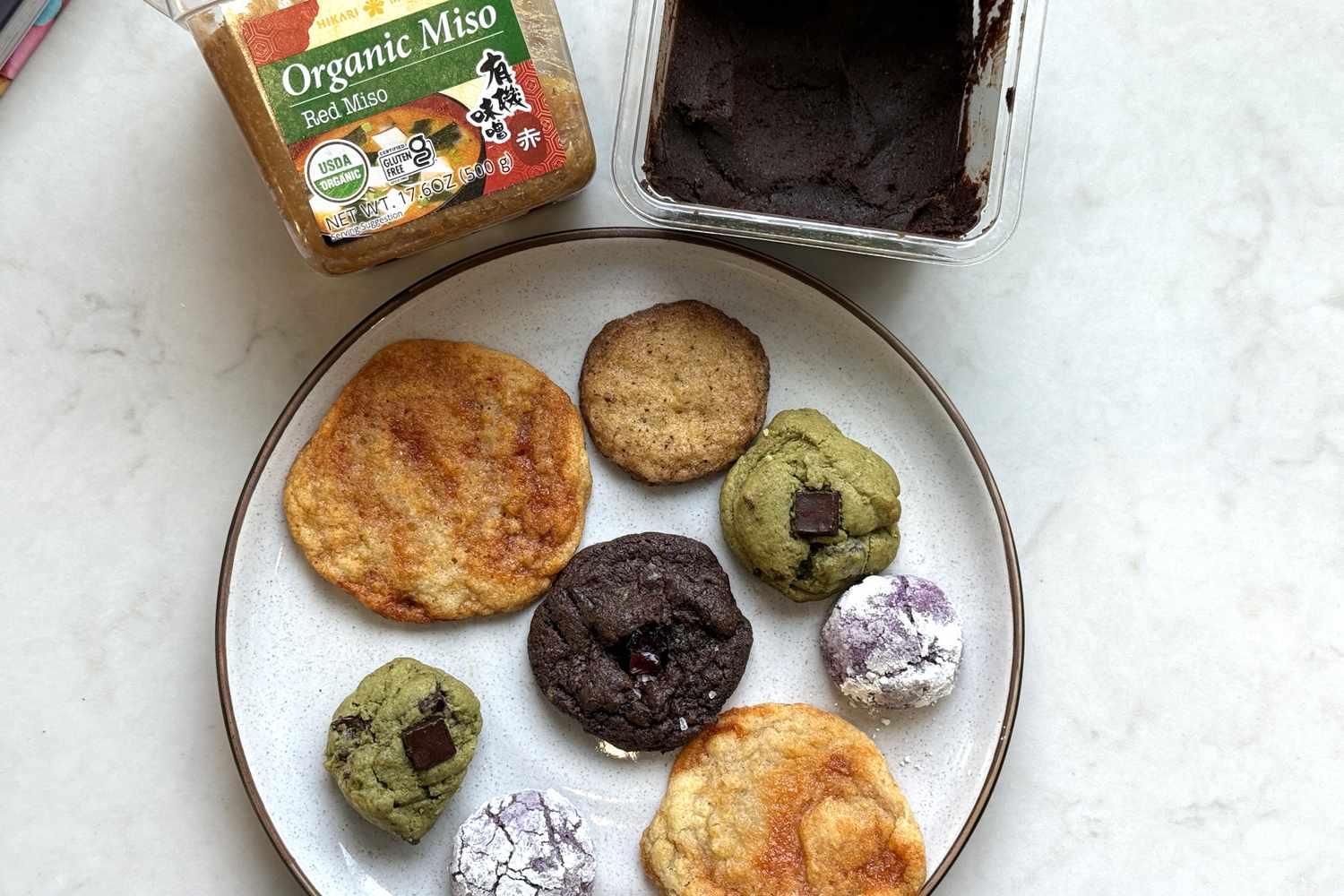 Plate of various cookies with containers of organic miso paste in the background