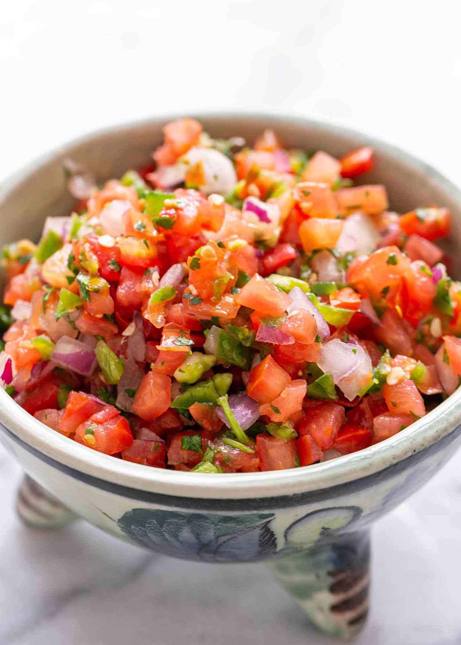 fresh tomato salsa close up on chopped tomatoes