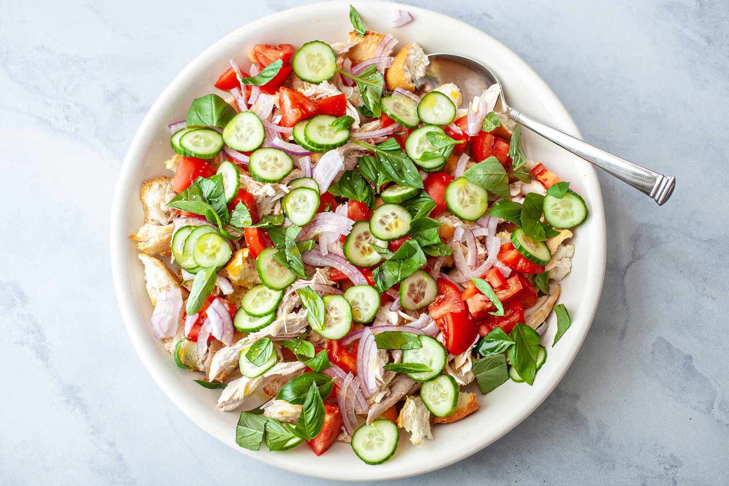 What is Panzanella? overhead shot of panzanella in white bowl