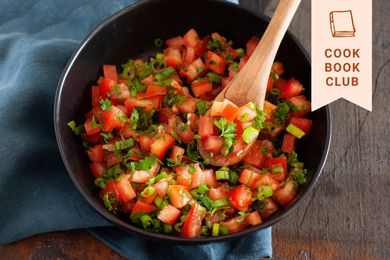 Overhead view of ‘In Bibi’s Kitchen’ Lasary Legioma Recipe in a dark bowl with a wooden spoon.